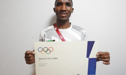 Alphonce Simbu holding his Tokyo 2020 Olympic Games Diploma